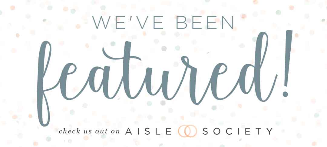 Image with the text "We've been featured! Check us out on Aisle Society" on a white background with pastel dots.