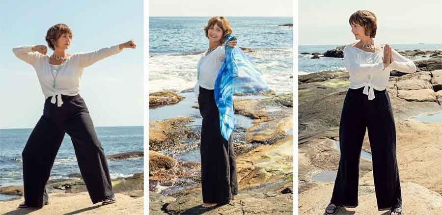 A woman in a white blouse and black wide-leg pants poses on a rocky shoreline with the ocean in the background. In one image, she holds a blue scarf.