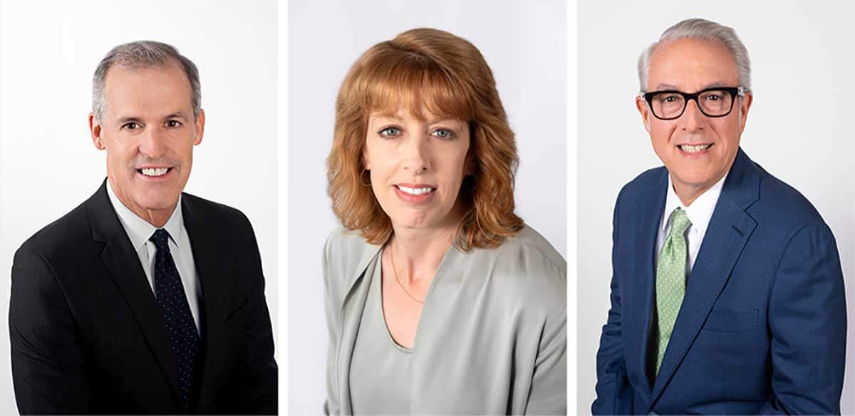 Three adults in business attire pose for professional headshots against a plain white background; two men and one woman.