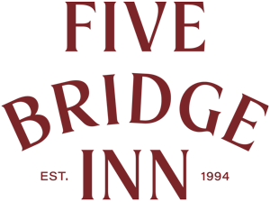 Logo for Five Bridge Inn with the words "FIVE BRIDGE INN" in red capital letters, and "EST. 1994" below.