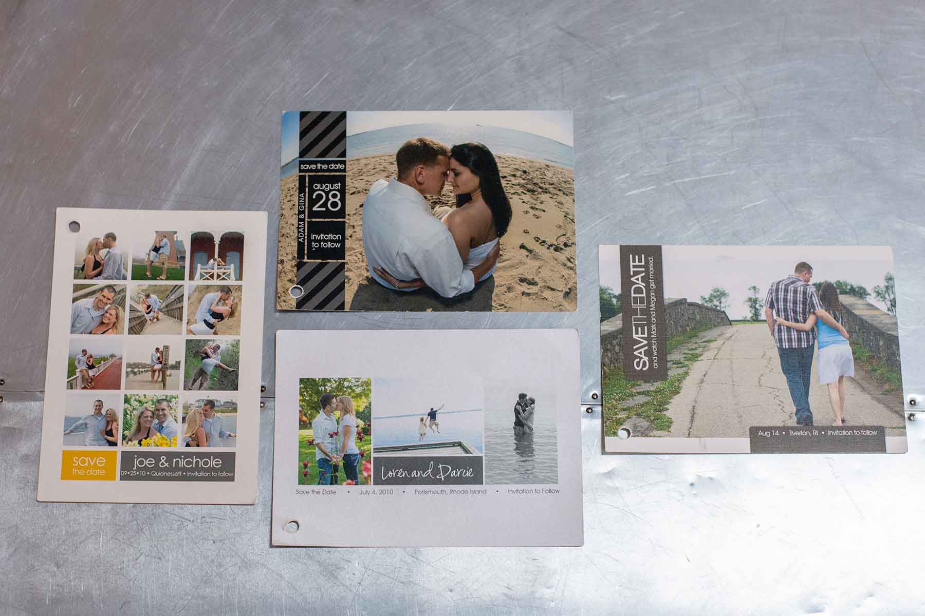 Four "save the date" wedding cards with couples' photos are displayed on a metallic surface. Each card features different layouts and outdoor scenes.