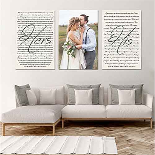 print-products-wall-art A living room with a white sectional sofa and gray-and-white pillows. Above the sofa are three wall art pieces: a wedding photo in the center, flanked by “Hers” and “His” vow prints.