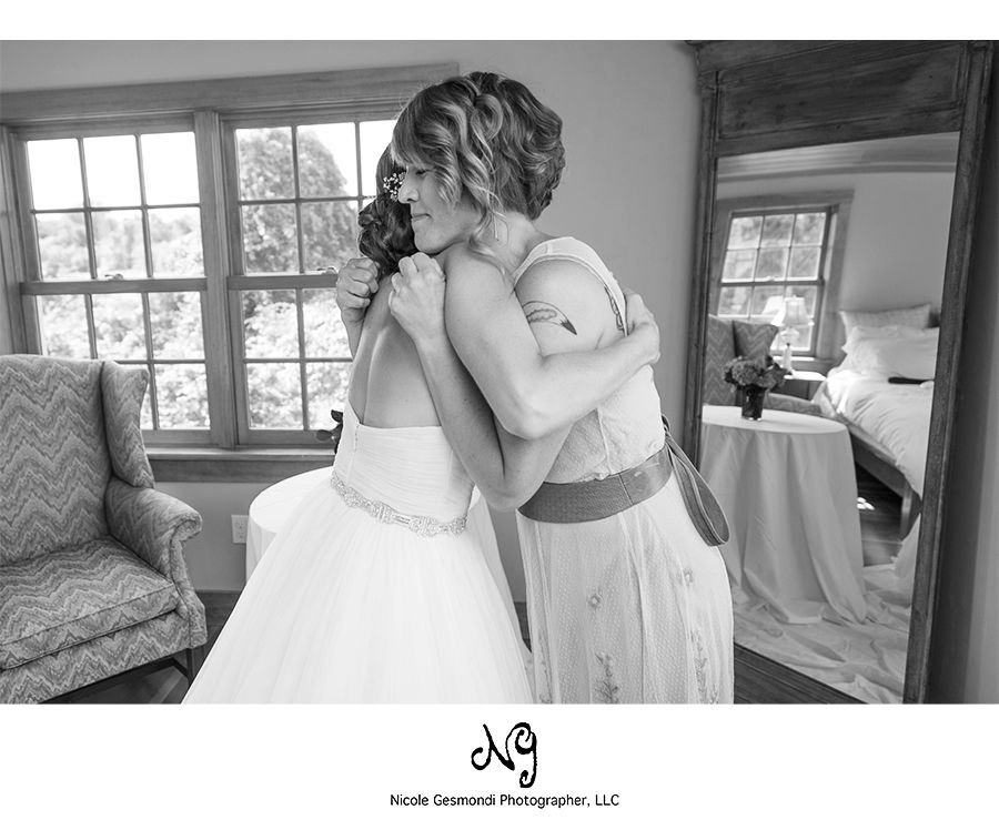 black and white photo of a bride hugging her sister black and white photo of a bride hugging her sister