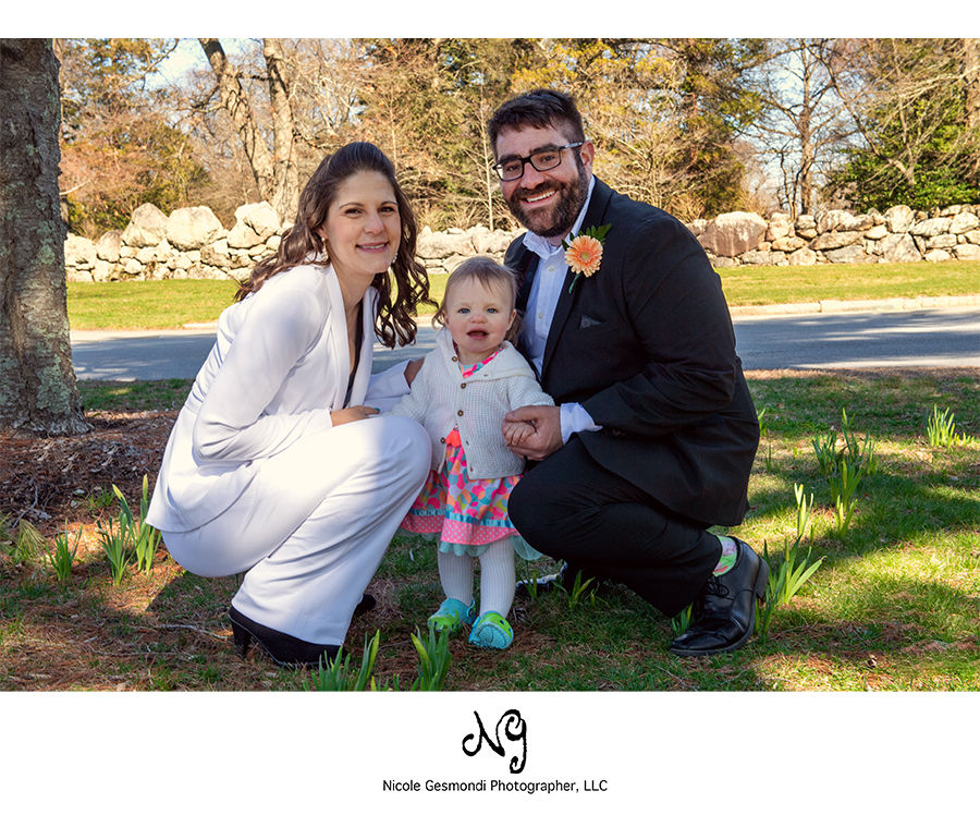photo of bride and groom with their one year old daughter