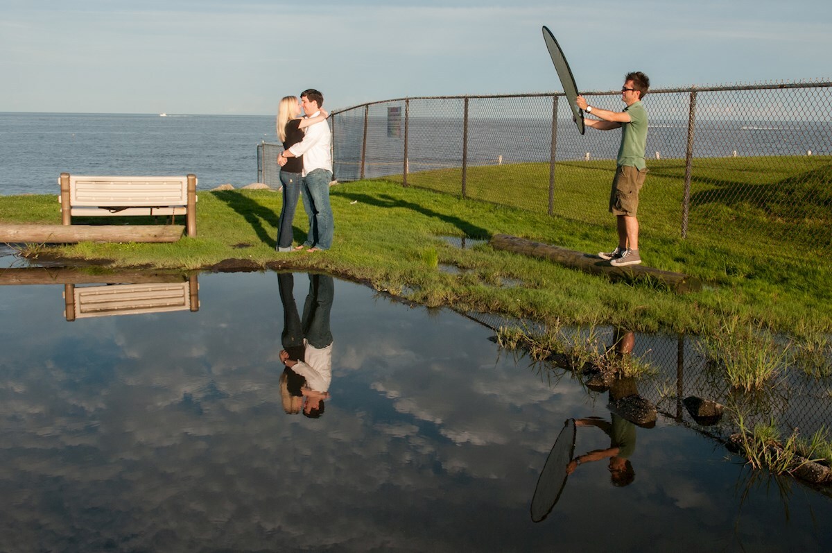 Paul holding a reflector during an engagement session behind the scenes photo assistant