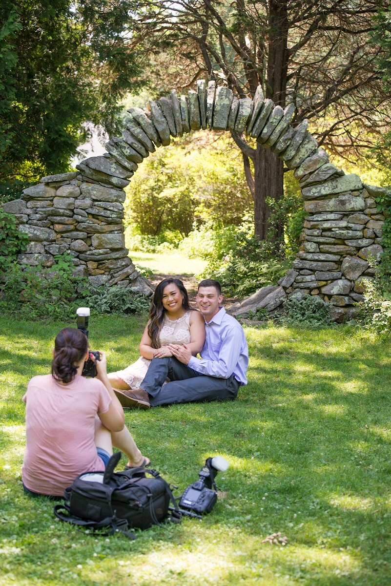 Nicole taking a photo of her couple during their engagement session